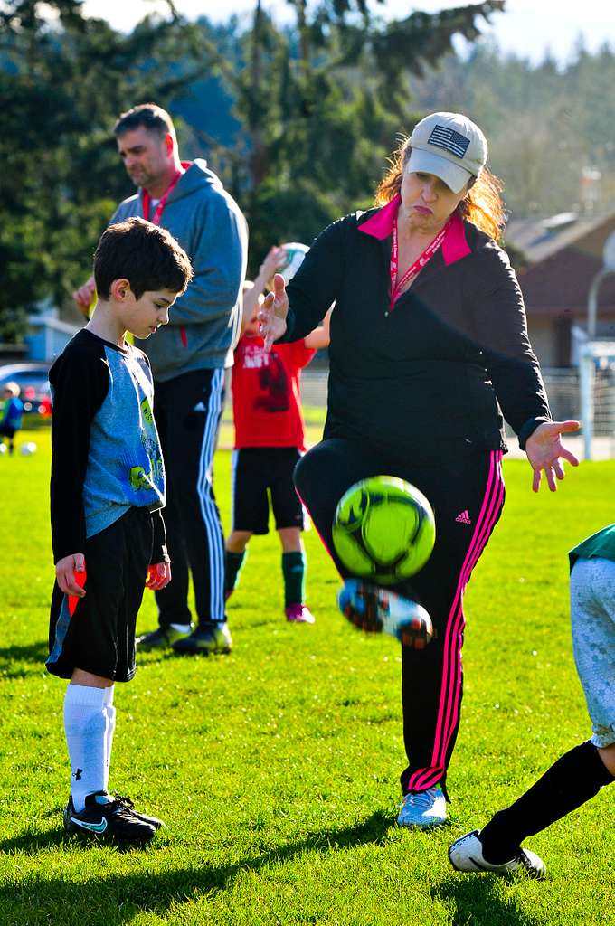 PHOTO: NARA&DVIDS Public Domain Archive
A youth soccer coach teaching a player.